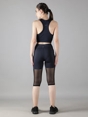 Rear view of Waylene's navy blue track suit set, highlighting the sports bra and capri tights with mesh details, perfect for training sessions.