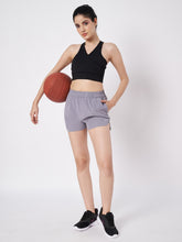 Waylene Grey Polyester Shorts with Elastic Waistband and Side Pockets, front view with model holding basketball