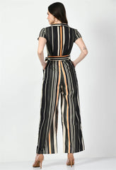 Rear view of Waylene's striped multi-color jumpsuit with a collared top and tie waist. Model poses looking over her shoulder, highlighting the back details against a white background.