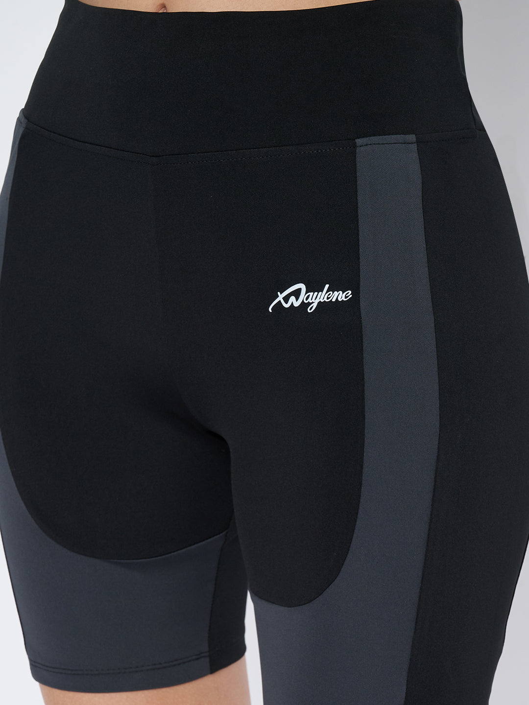 Close-up of Waylene Gym Shorts, featuring logo and color block design.