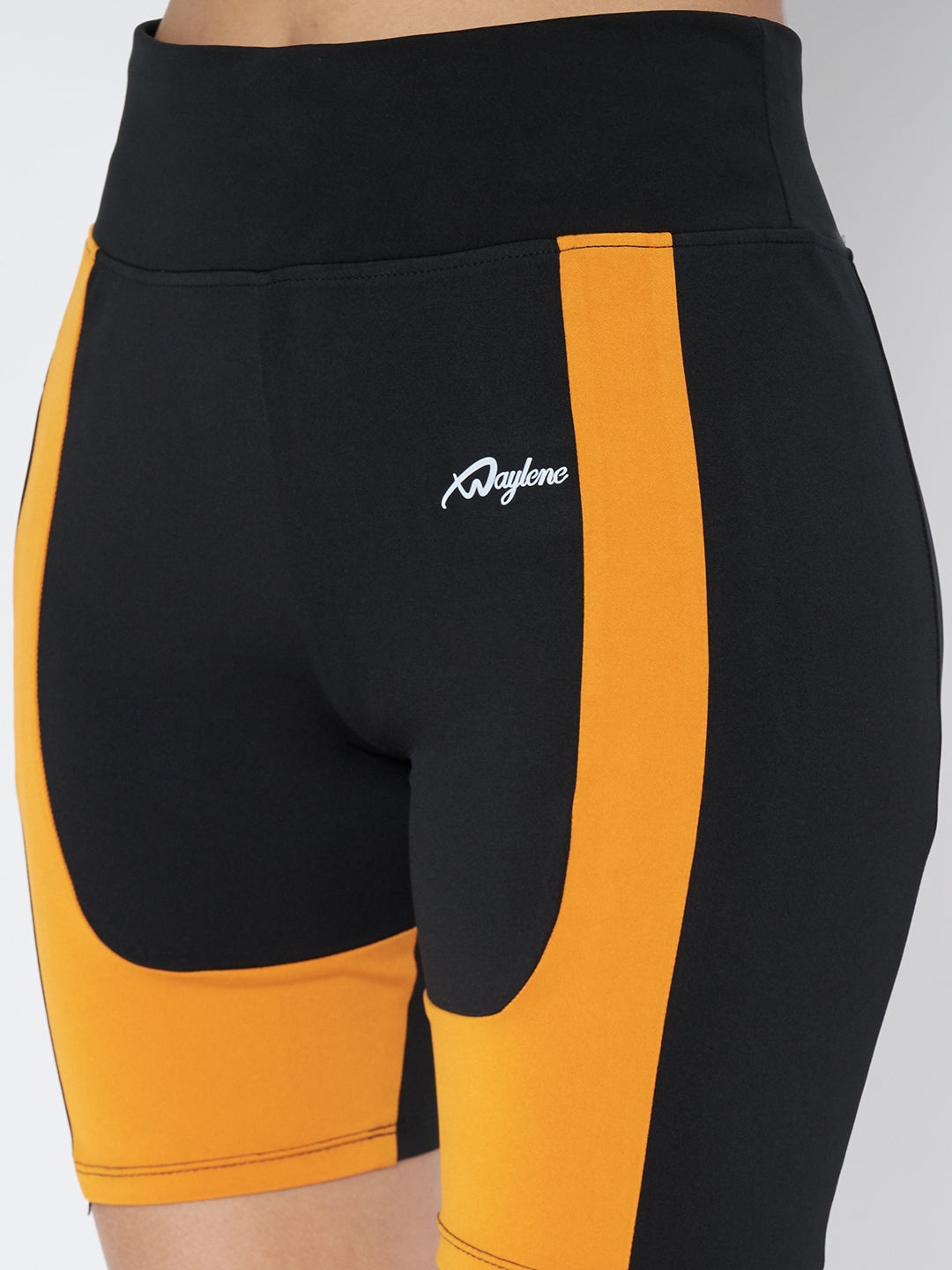 Close-up rear view of Waylene's high-waist sports shorts in black and orange, highlighting the subtle logo placement and color contrast.