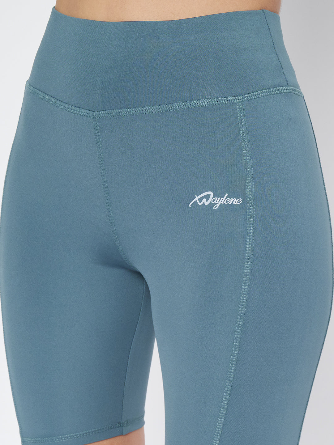 Close-up back view of Waylene's light blue high-waist cycling shorts on a woman, focusing on the detailed stitching and waistband logo.