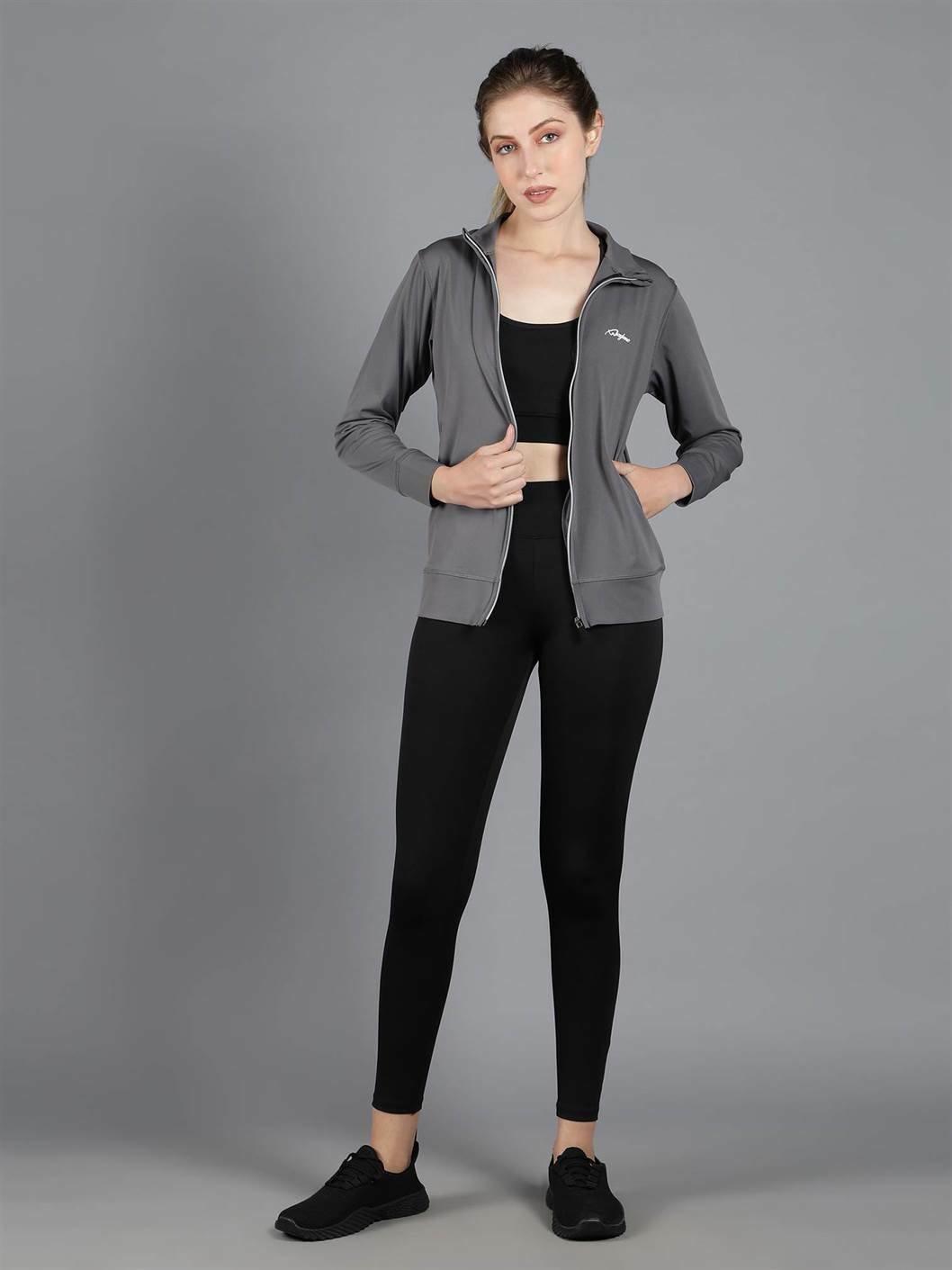 Waylene's grey sweatshirt styled casually open with a white crop top underneath, shown on a model in a relaxed pose with hands in pockets, highlighting the versatility and layering potential of the piece.