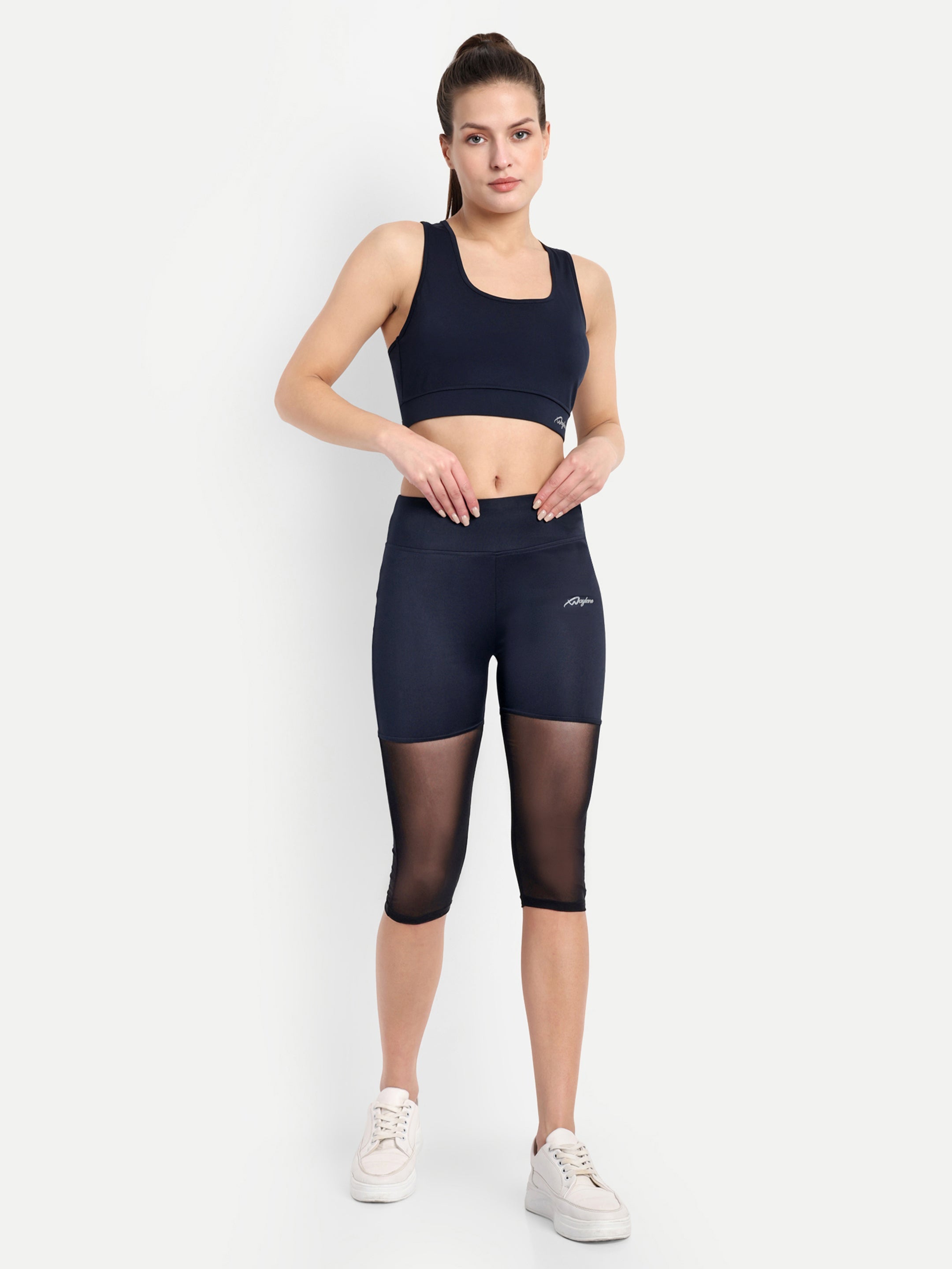 Model wearing Waylene Navy Blue High-Waisted Capri Leggings with Mesh Inserts, full outfit view.