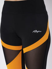 Close-up of Waylene black and orange sports leggings with mesh panels
