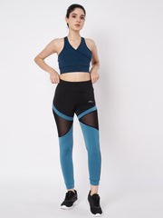 Waylene high-waisted leggings in blue and black with mesh details, paired with a sports bra.