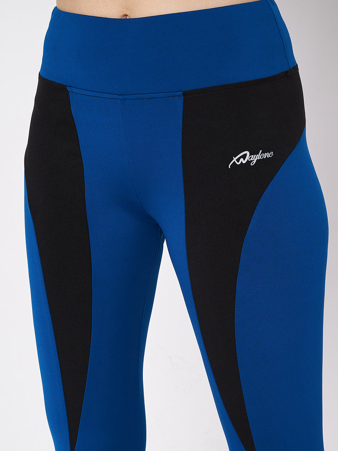 Close-up of Waylene blue and black sports leggings, featuring logo and color block design.