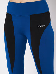 Close-up of Waylene blue and black sports leggings, featuring logo and color block design.
