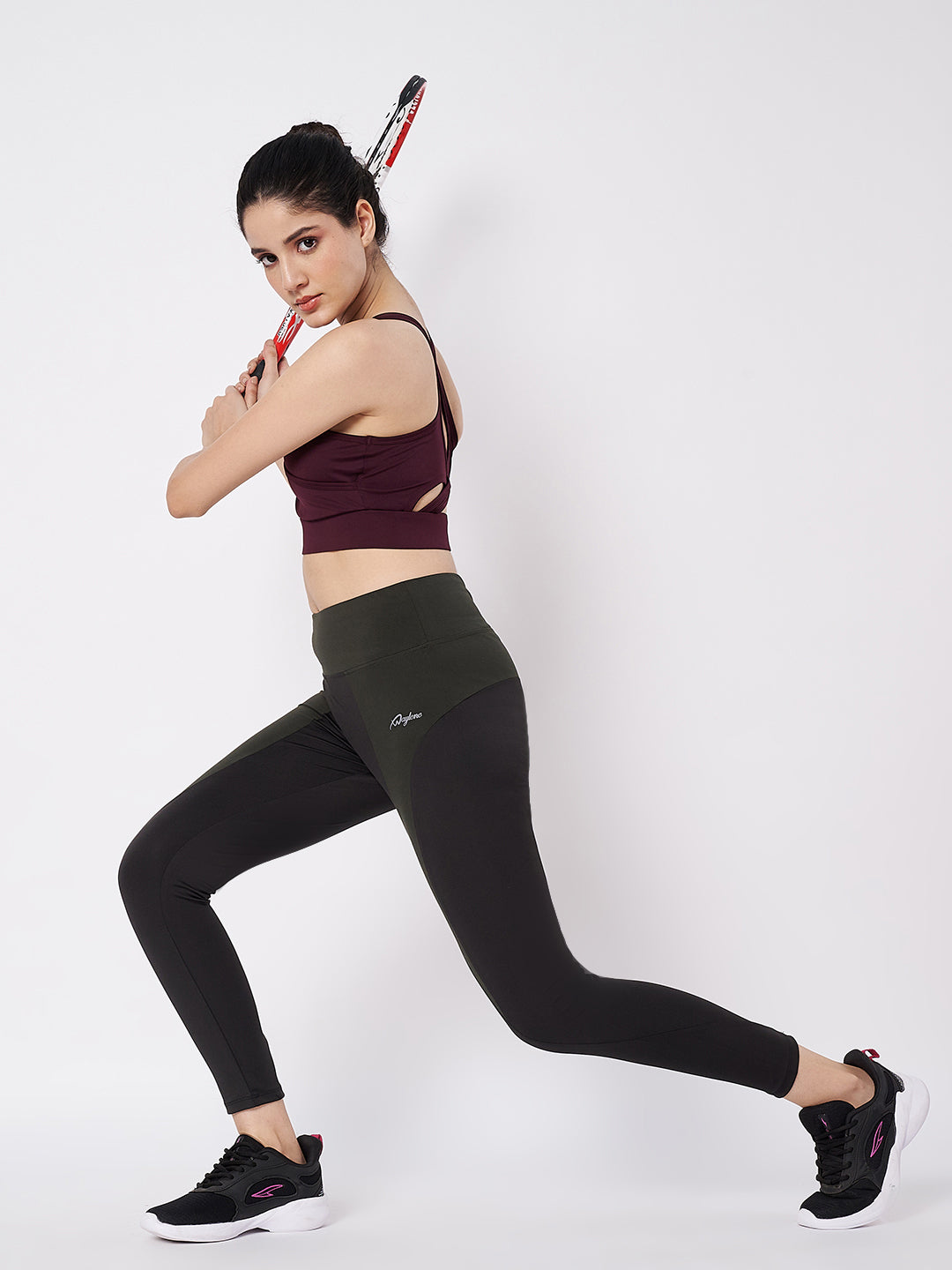 Waylene black and olive leggings in action with tennis pose