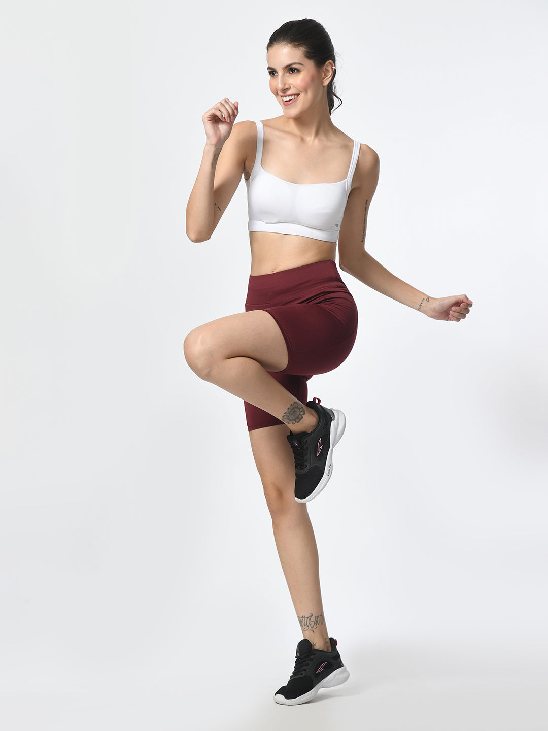 Waylene wine-colored high-performance shorts with pocket, women's activewear, model in active pose.