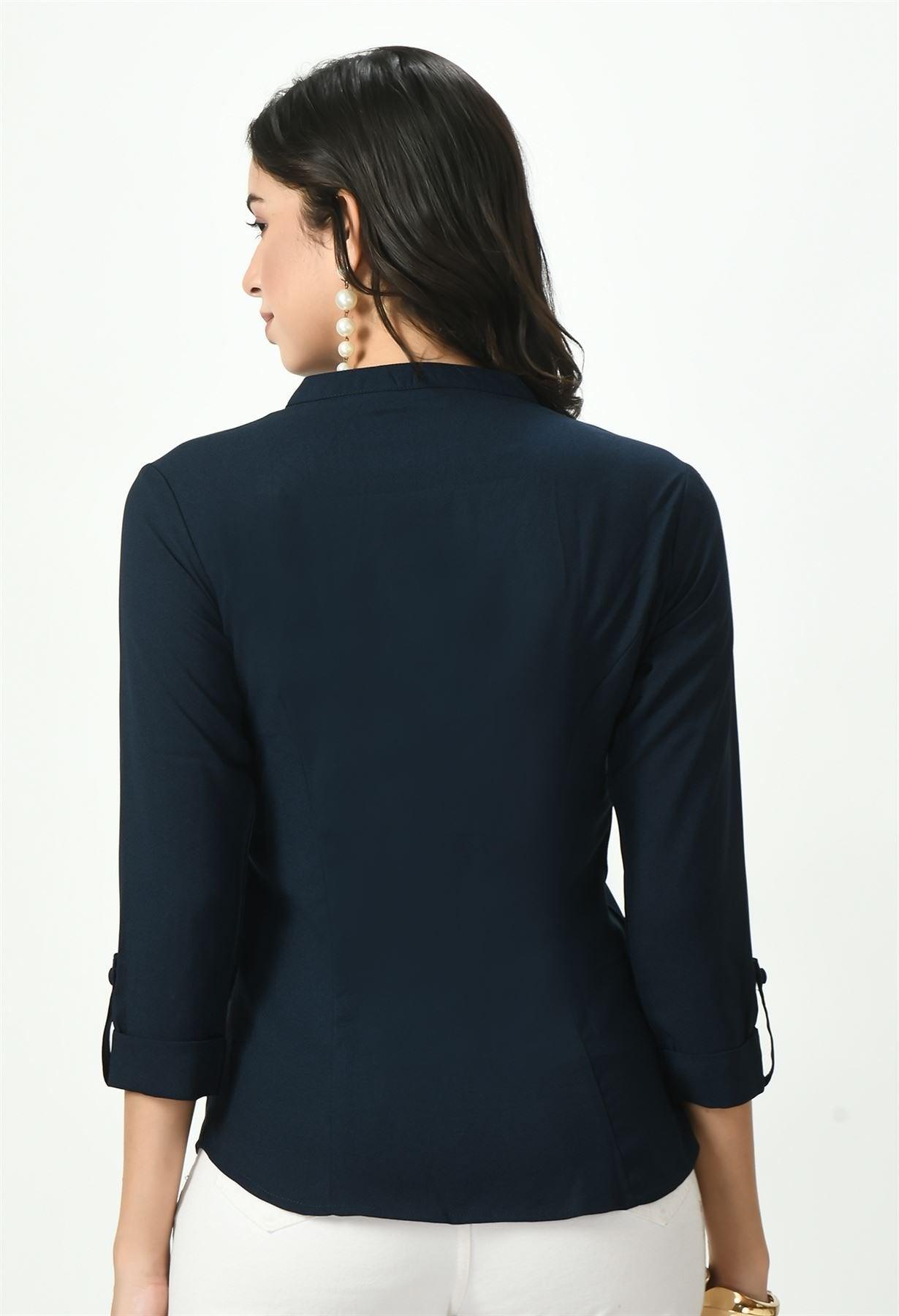 Rear view of a woman wearing a dark navy blue Waylene button-up top, showing the back design and fit.