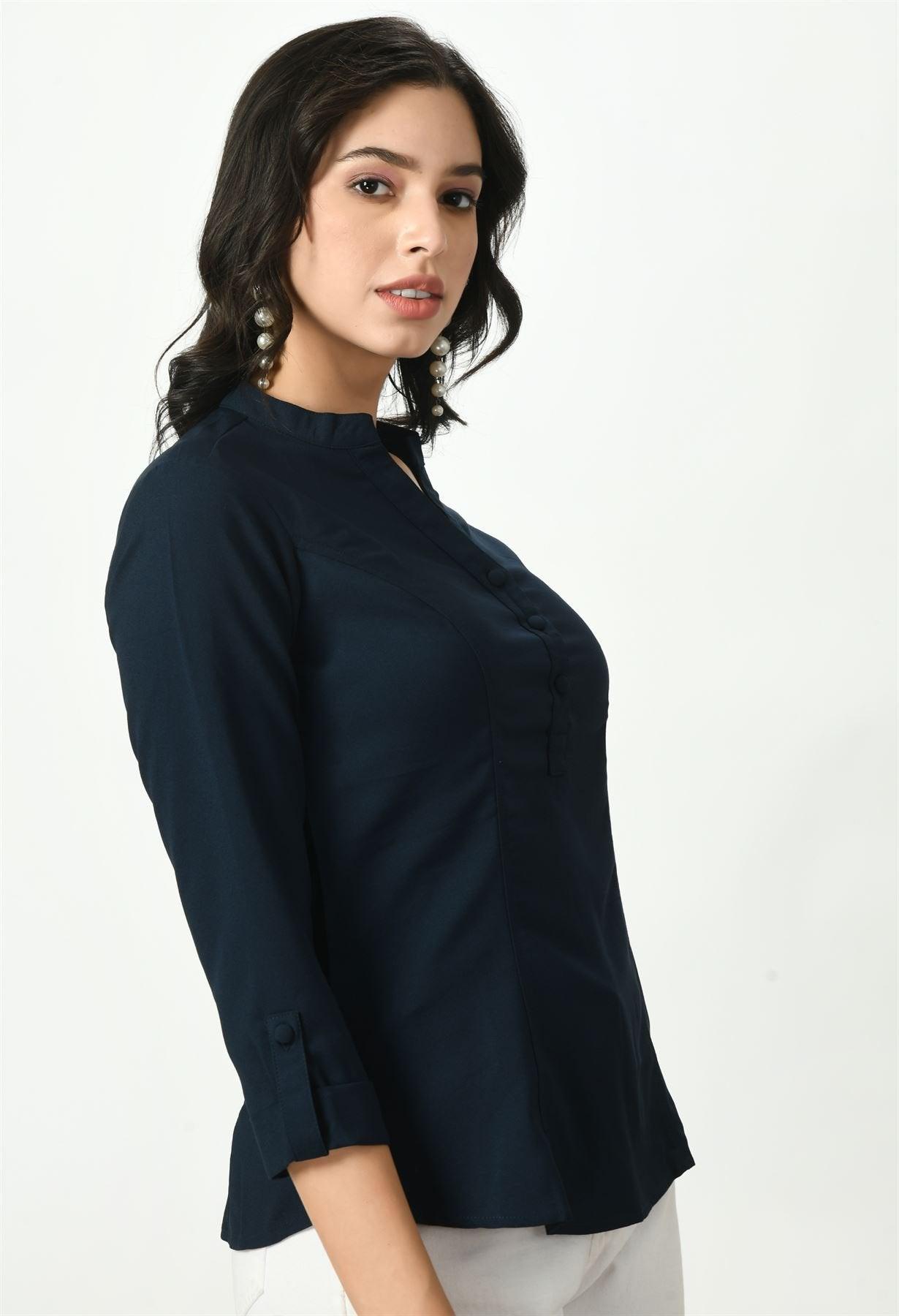 A close-up side view of a woman wearing a dark navy blue Waylene button-up top, highlighting its fitted design and button details.